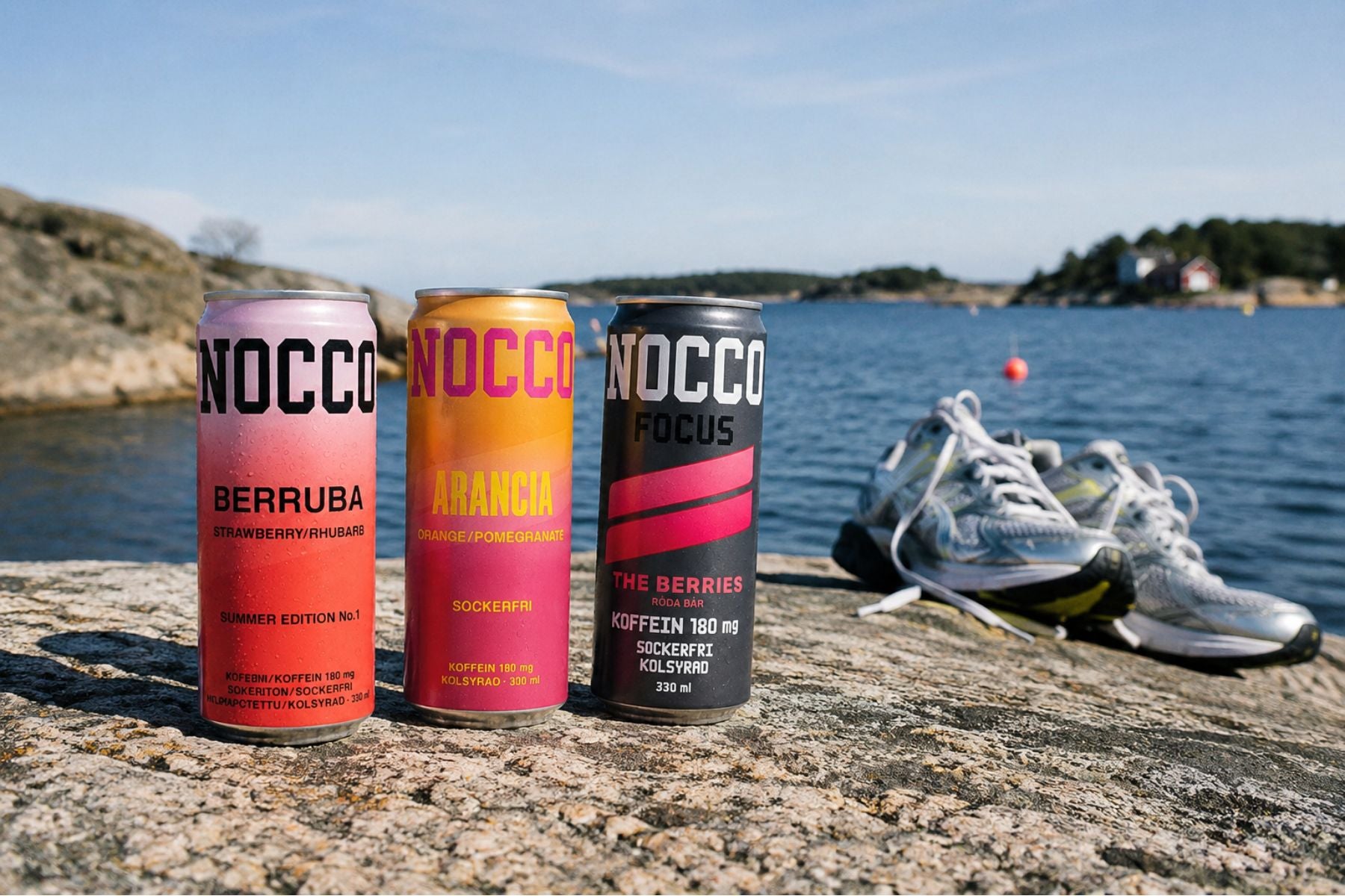 Three Nocco energy drinks with water and shoes nearby.