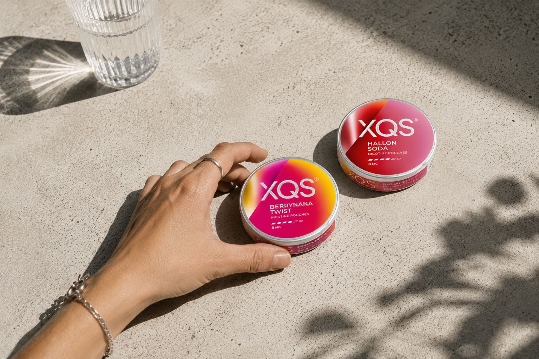 Hand with XQS cans