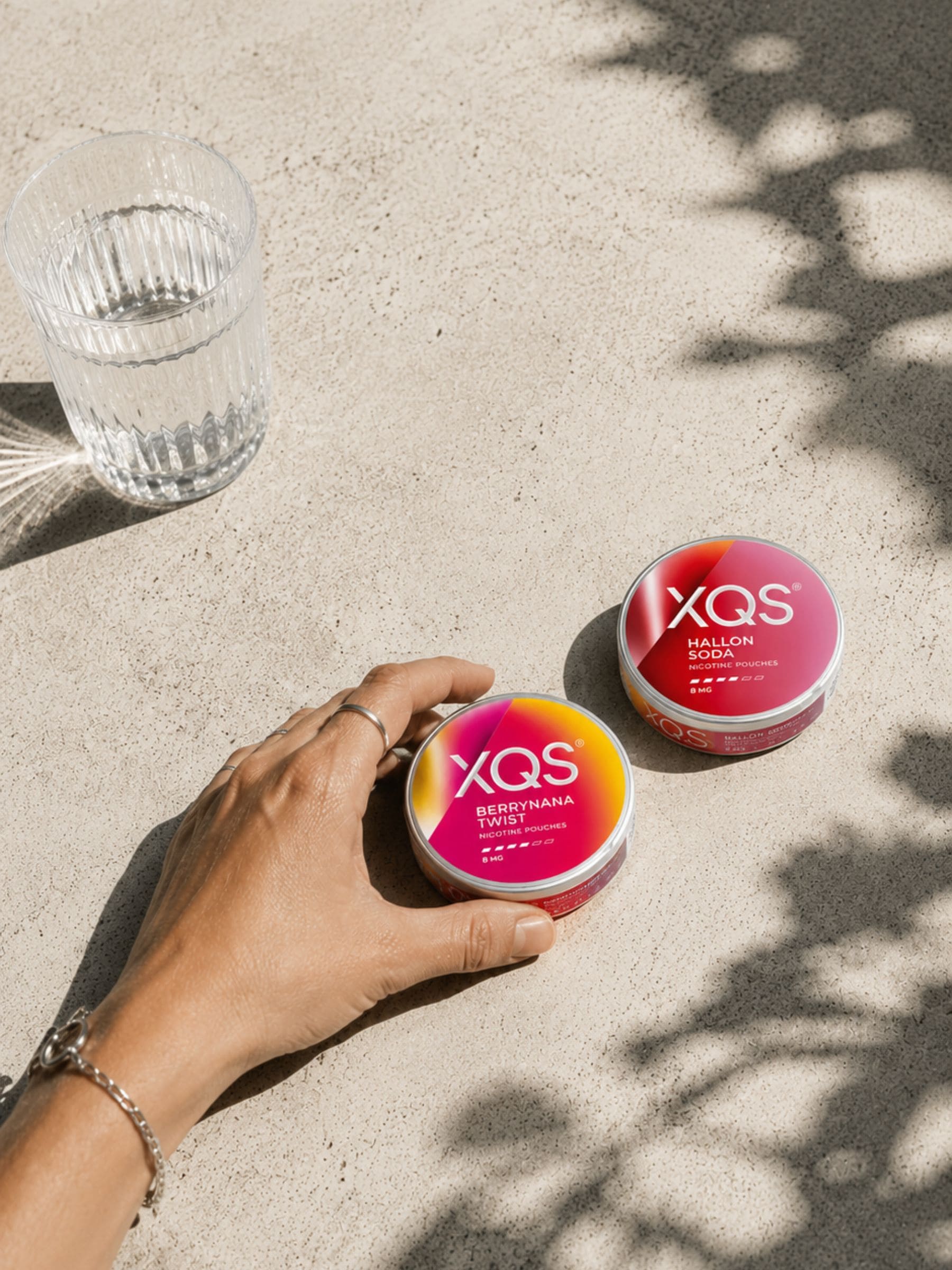 Hand with XQS cans
